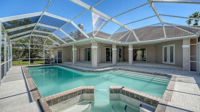 view of pool featuring french doors, a patio, a lanai, and a pool with connected hot tub