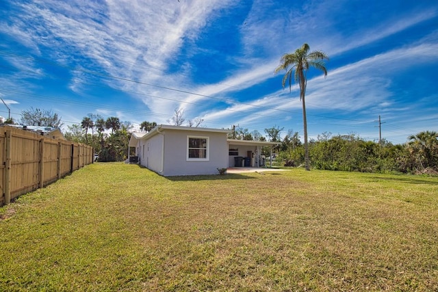 view of yard featuring fence and a patio