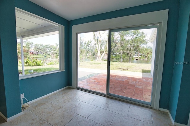 doorway to outside with baseboards