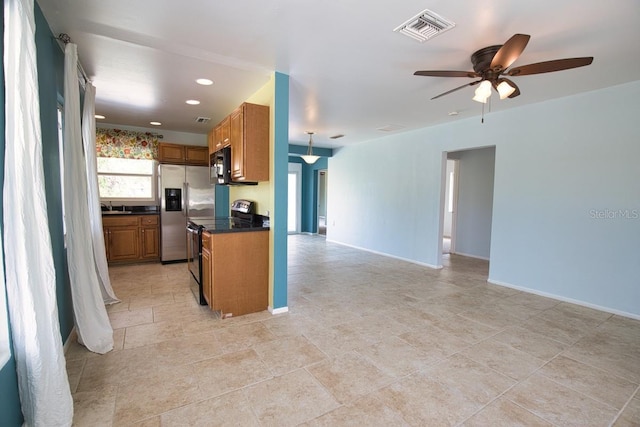 kitchen featuring range with electric stovetop, dark countertops, visible vents, open floor plan, and black microwave