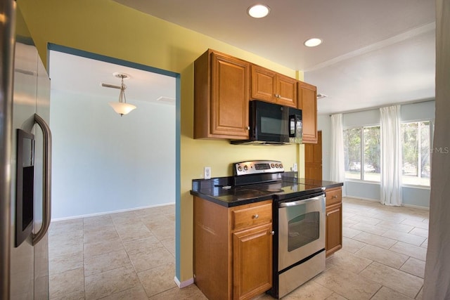 kitchen with tile counters, recessed lighting, appliances with stainless steel finishes, brown cabinetry, and baseboards