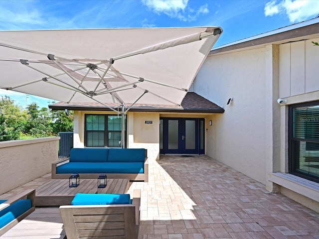 view of patio with a deck, french doors, and an outdoor living space