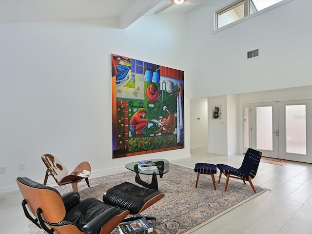 living area featuring french doors, beam ceiling, visible vents, high vaulted ceiling, and baseboards