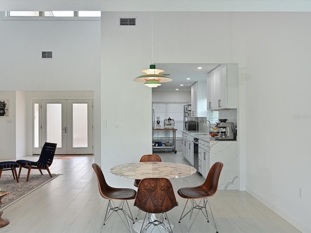 dining room featuring a wealth of natural light, french doors, and visible vents