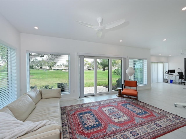 interior space with a ceiling fan, recessed lighting, and wood finished floors