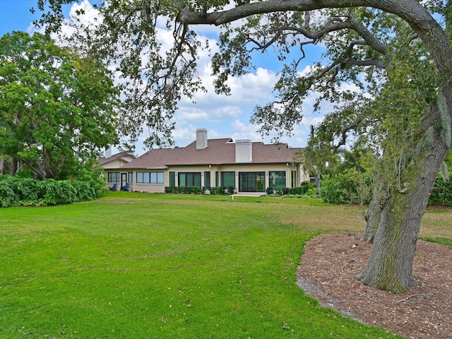 exterior space with a chimney and a front lawn