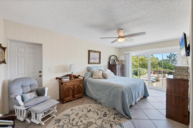 bedroom featuring light tile patterned floors, a textured ceiling, a ceiling fan, and access to outside