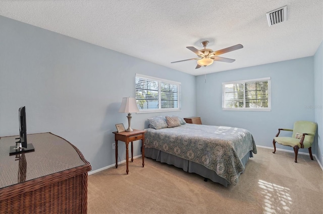 bedroom with light colored carpet, visible vents, and baseboards