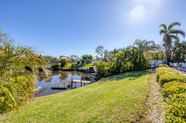 dock area featuring a water view and a lawn