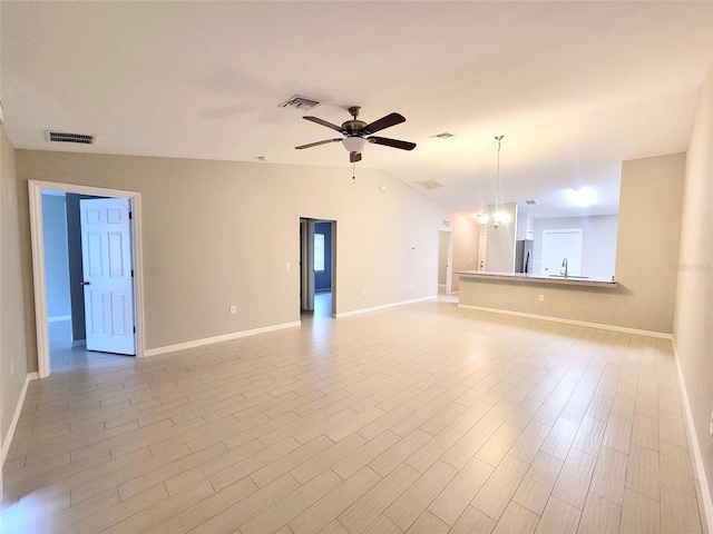 unfurnished living room with visible vents, light wood-style floors, a ceiling fan, and vaulted ceiling