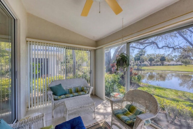 sunroom / solarium with vaulted ceiling, ceiling fan, a water view, and a wealth of natural light