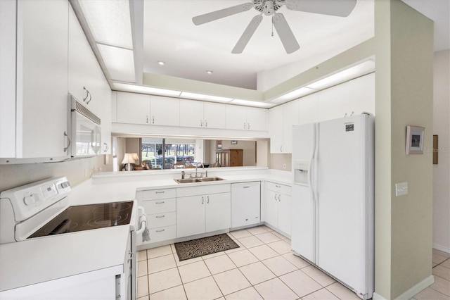 kitchen featuring light countertops, light tile patterned flooring, a sink, white cabinets, and white appliances