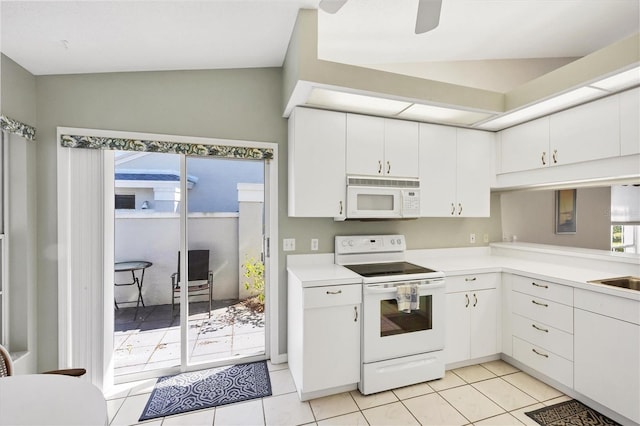 kitchen with light countertops, white appliances, white cabinetry, and light tile patterned flooring