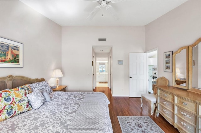 bedroom featuring a ceiling fan, wood finished floors, visible vents, and baseboards