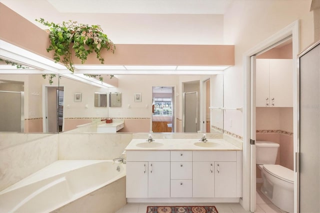 bathroom with double vanity, a sink, toilet, and a bath