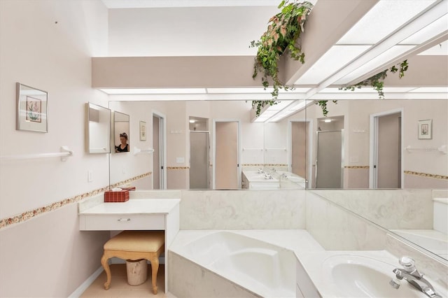 bathroom featuring a stall shower, tile patterned floors, a bath, and vanity