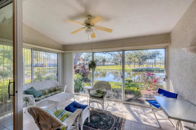 sunroom featuring ceiling fan, a water view, and lofted ceiling