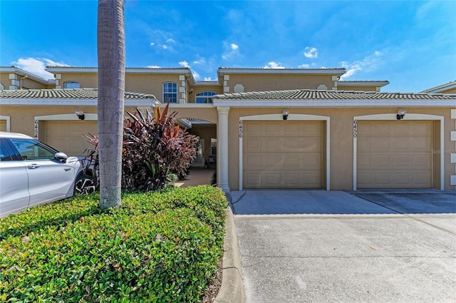 view of front of house with driveway and stucco siding