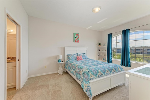 bedroom with light carpet and baseboards