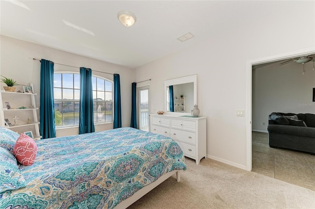 bedroom featuring light carpet, visible vents, and baseboards