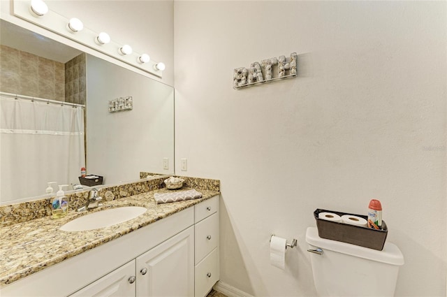 bathroom with toilet, curtained shower, and vanity