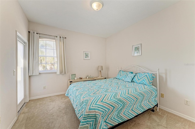 carpeted bedroom featuring baseboards