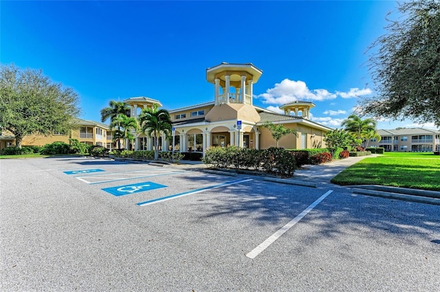 view of property featuring uncovered parking