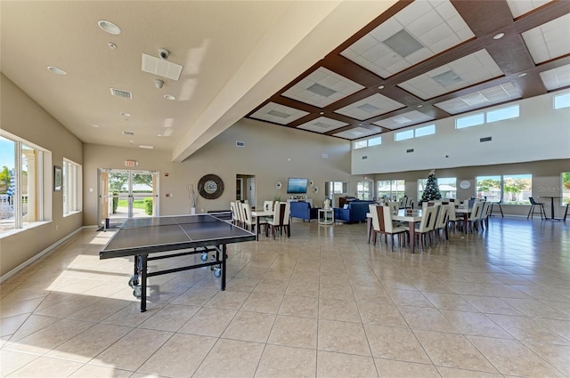 rec room featuring light tile patterned floors, a high ceiling, visible vents, and coffered ceiling