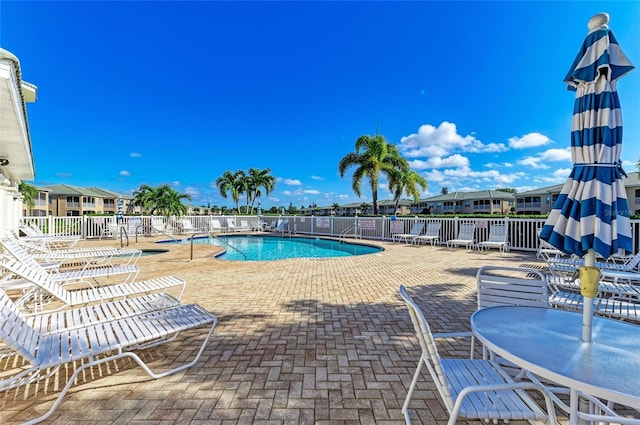 pool featuring a patio area and fence