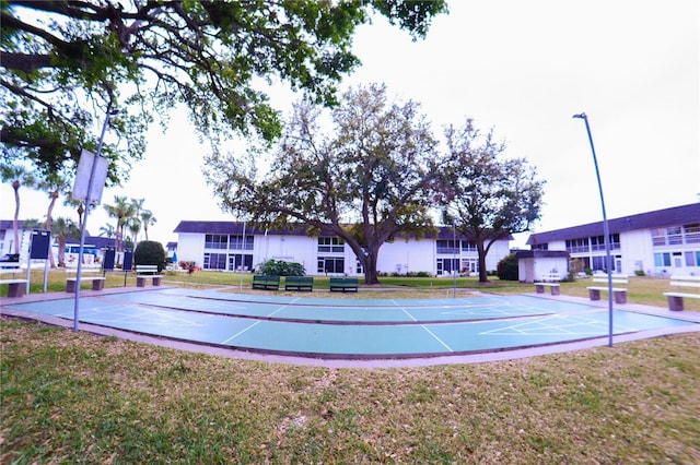 view of property's community with a yard and shuffleboard