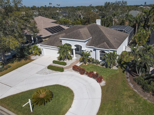 view of front of house featuring stucco siding, a shingled roof, an attached garage, driveway, and a front lawn