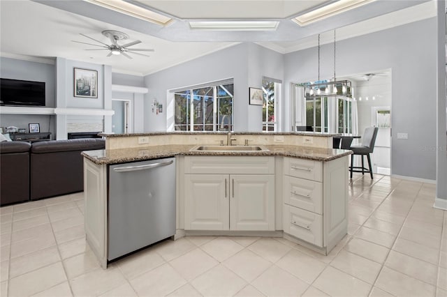 kitchen featuring ornamental molding, open floor plan, a sink, dishwasher, and ceiling fan with notable chandelier