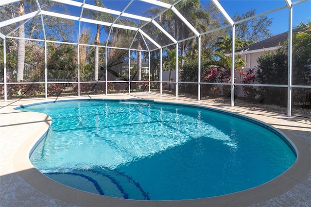 view of swimming pool with a lanai, a fenced in pool, and a patio