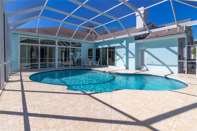 outdoor pool with a lanai and a patio