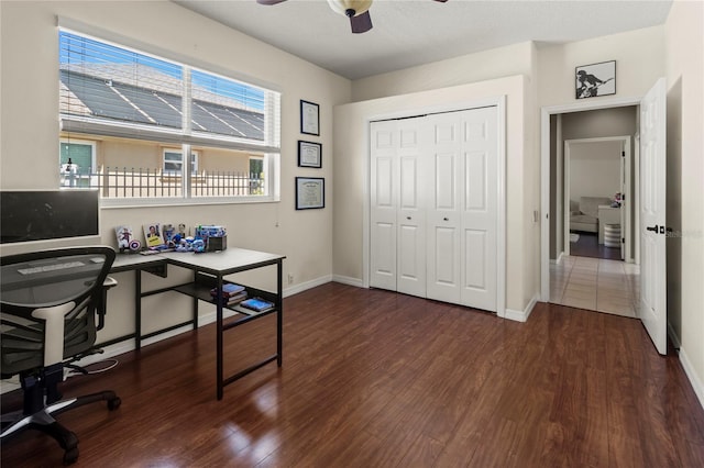 office space featuring dark wood-style floors, ceiling fan, and baseboards