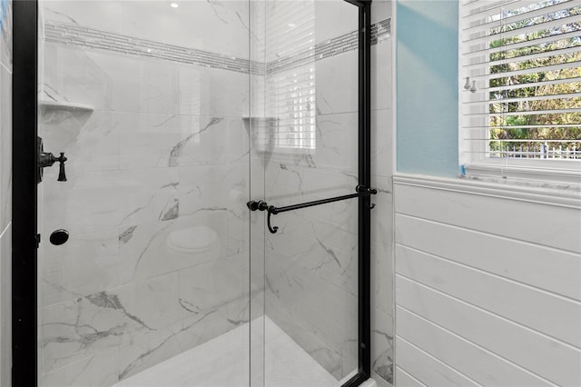 full bathroom with a marble finish shower