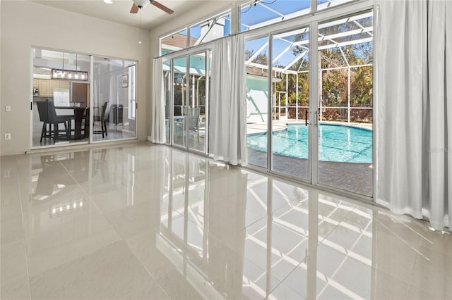 interior space with a sunroom and a ceiling fan