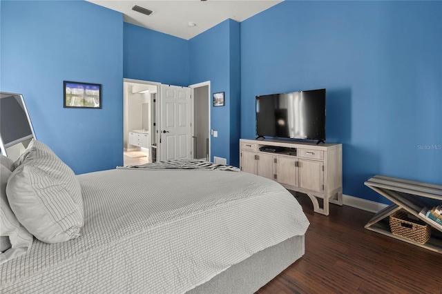 bedroom featuring dark wood-type flooring, visible vents, and baseboards