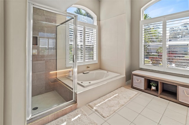 bathroom with a stall shower, a garden tub, and tile patterned floors