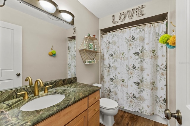 full bath with toilet, curtained shower, wood finished floors, and vanity