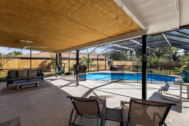 view of pool with a fenced in pool, an outdoor hangout area, glass enclosure, a patio area, and a fenced backyard