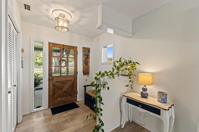 entryway with light wood-type flooring and visible vents