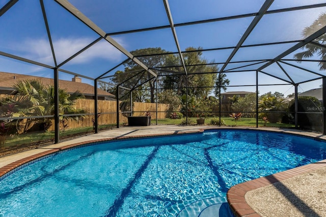 view of pool with a lanai, a patio area, fence, and a fenced in pool