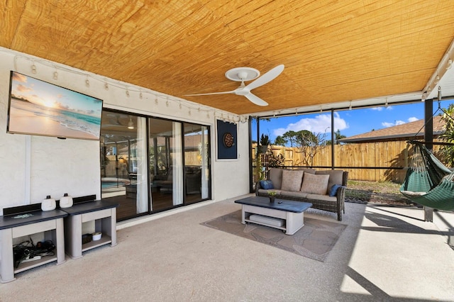 view of patio featuring fence, outdoor lounge area, and a ceiling fan