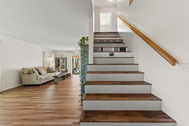 stairs featuring wood finished floors