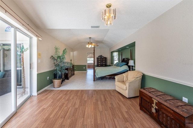 bedroom with light wood-type flooring, access to outside, a chandelier, and vaulted ceiling