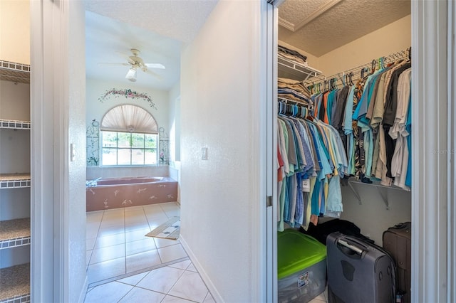 spacious closet featuring tile patterned floors and a ceiling fan