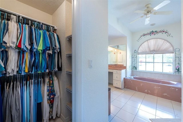 spacious closet featuring tile patterned flooring and a ceiling fan