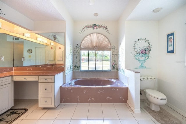 bathroom with toilet, a bath, vanity, and tile patterned flooring