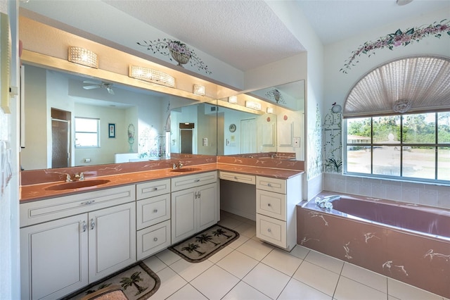 bathroom with a sink, a garden tub, double vanity, and tile patterned flooring